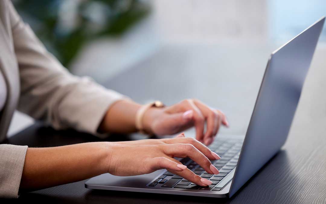 invoicing time is money cropped shot of a young businesswoman working on laptop